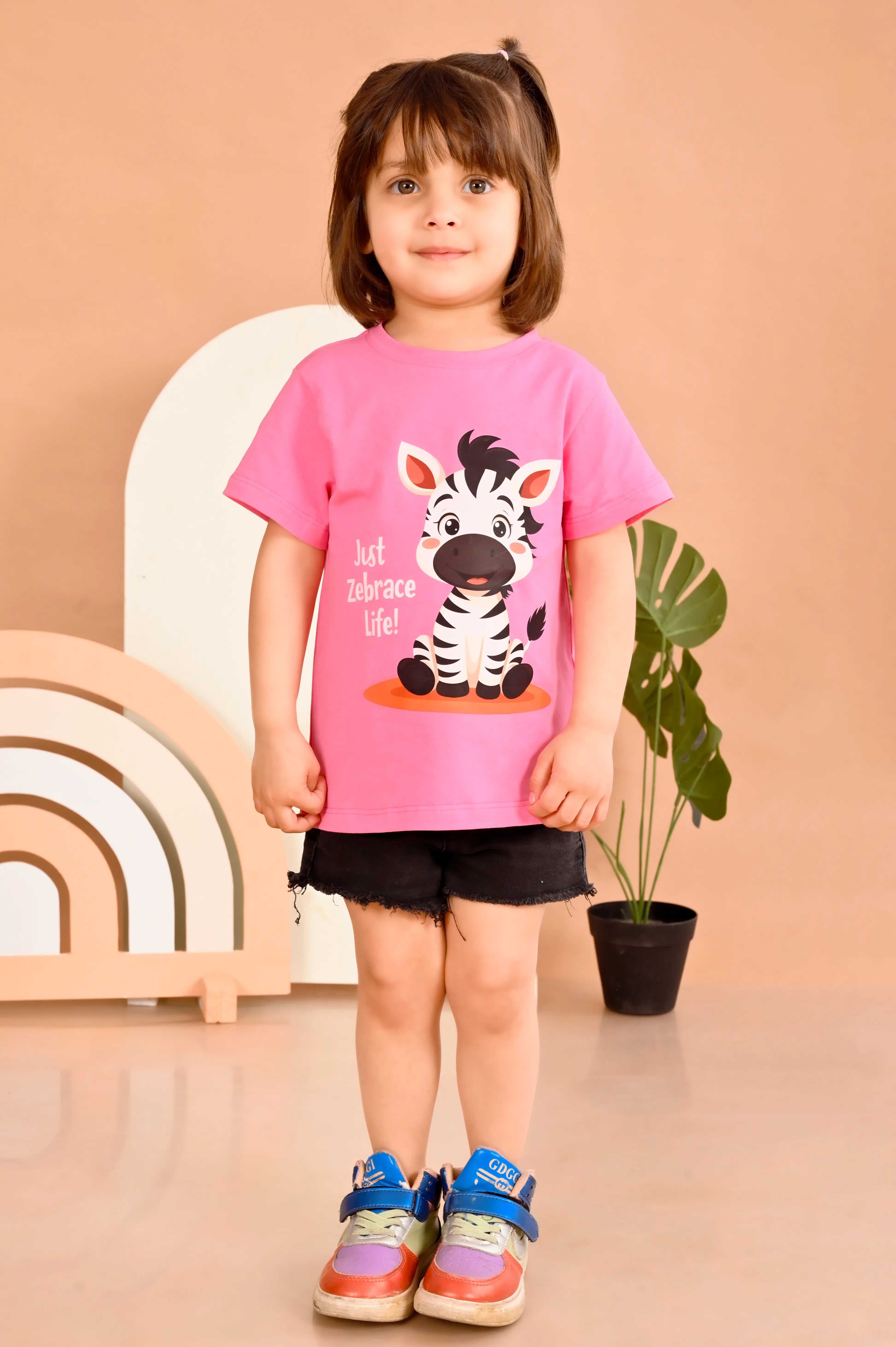 Child wearing a pink t-shirt with a zebra design made out of 100% pure cotton material